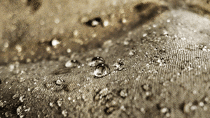 Water beading off a rainjacket after using the DFNS Water Repellent wash detergent to reactivate its DWR coating and protective properties.