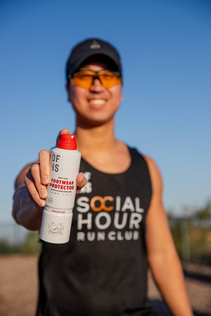 Captain of Social Hour Run Club holding the DFNS Footwear Protector spray